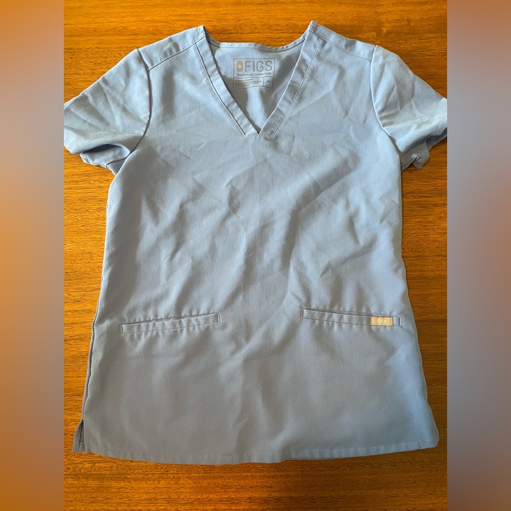Figs light blue technical scrub top, short sleeved size XS, two pockets